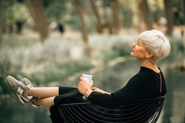 Older woman sitting outside on her wellness journey to improve gut health and mental health with psychedelic therapy